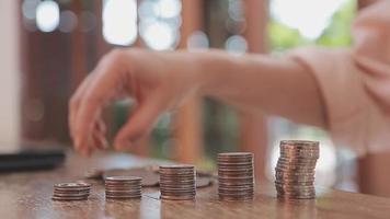 businessman holding coins putting in glass with using calculator to calculate concept saving money for finance accounting, Business, finance, investment, Financial planning. video