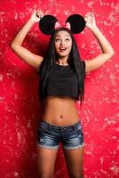 I got so cute ears Playful young African woman in mouse ears posing against white background and smiling photo