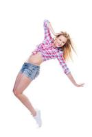 Carefree beauty. Full length of attractive young woman in funky wear dancing against white background photo