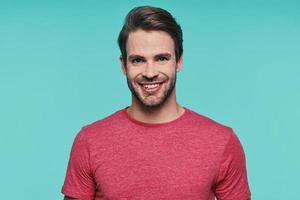 Portrait of handsome young man in casual wear looking at camera and smiling photo