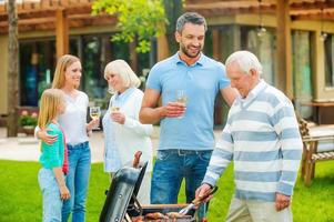 Spending quality time with family. Happy family of five people spending time on the back yard together photo