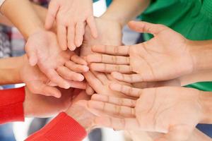 We are all people. Top view of people holding their palms together photo