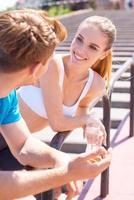 Sporty couple. Young couple in sports clothing standing face to face and smiling photo