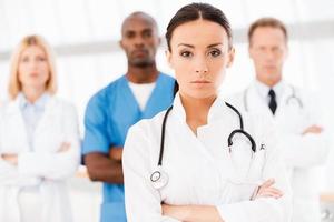 Confident doctor leading her team. photo