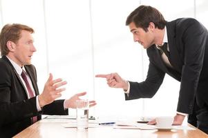 It is your fault Two young men in formalwear arguing while one of them pointing his opponent photo