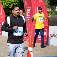 New Delhi, India - October 16 2022 - Vedanta Delhi Half Marathon race after covid in which marathon participants about to cross the finish line, Delhi Half Marathon 2022 photo