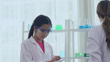 Asian schoolgirls are studying science and technology in a lab. Teachers teach science to students for learning process skills. video