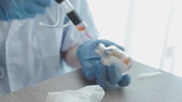 Medical Research Laboratory Portrait of a Female Scientist Wearing Face Mask Using Micro Pipette for Analysis. Advanced Scientific Lab for Medicine, Biotechnology Development. Close-up Shot video