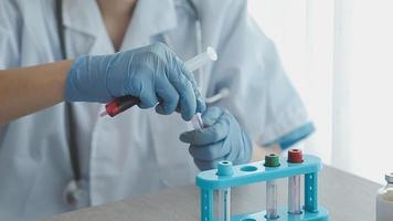 Medical Research Laboratory Portrait of a Female Scientist Wearing Face Mask Using Micro Pipette for Analysis. Advanced Scientific Lab for Medicine, Biotechnology Development. Close-up Shot video