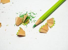 Artist's workshop. School supplies.  . Multicolored pencils. Wood and graphite shavings. The process of preparing for work. Creative mess photo