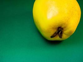 Juicy quince. Fruit on a green background. Ripe useful product. photo