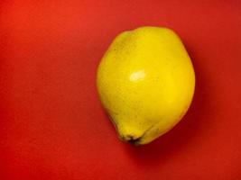 Juicy quince. Fruit on a red background. Ripe useful product. photo