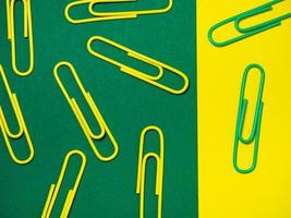 Office work. Colored paper clips. Colored paper with staples.  Colorful office supplies. photo