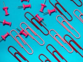 Office work. Colored paper clips. Colored paper with staples.  Colorful office supplies. photo