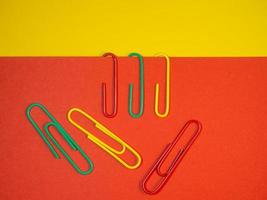 Large multi-colored paper clips. Paperclip of documents. Desktop. photo