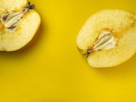 Juicy quince. Fruit on a yellow background. Ripe useful product. photo