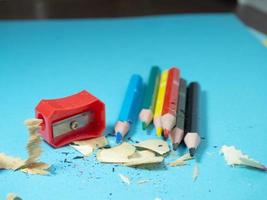 School supplies. Pencil sharpening.  Multicolored pencils. Wood shavings. The process of preparing for work. Creative mess photo