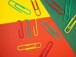 Large multi-colored paper clips. Paperclip of documents. Desktop. photo