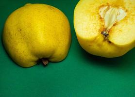 Juicy quince. Fruit on a green background. Ripe useful product. photo