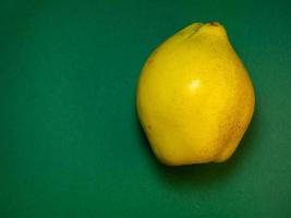 Juicy quince. Fruit on a green background. Ripe useful product. photo