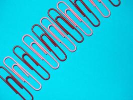 Office work. Colored paper clips. Colored paper with staples. Work with documents. photo