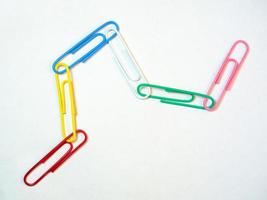 Large multi-colored paper clips. Paperclip of documents. Desktop. photo