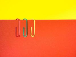 Large multi-colored paper clips. Paperclip of documents. Desktop. photo