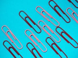 Office work. Colored paper clips. Colored paper with staples. Work with documents. photo