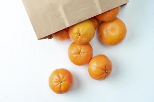 Alot of oranges in a paper bag. photo