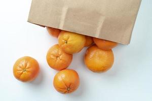 Alot of oranges in a paper bag. photo