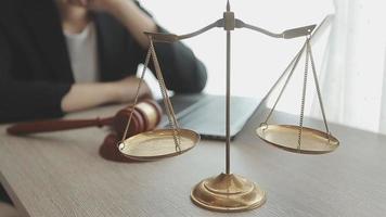 Business and lawyers discussing contract papers with brass scale on desk in office. Law, legal services, advice, justice and law concept video