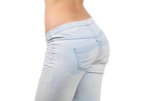 Female buttocks. Close-up of female buttocks in jeans isolated on white background photo