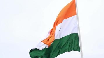 India flag flying high at Connaught Place with pride in blue sky, India flag fluttering, Indian Flag on Independence Day and Republic Day of India, tilt up shot, Waving Indian flag, Har Ghar Tiranga video