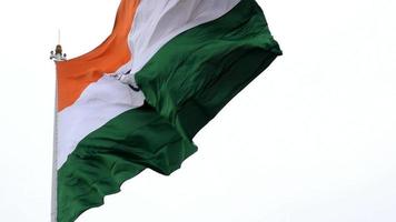 India flag flying high at Connaught Place with pride in blue sky, India flag fluttering, Indian Flag on Independence Day and Republic Day of India, tilt up shot, Waving Indian flag, Har Ghar Tiranga video