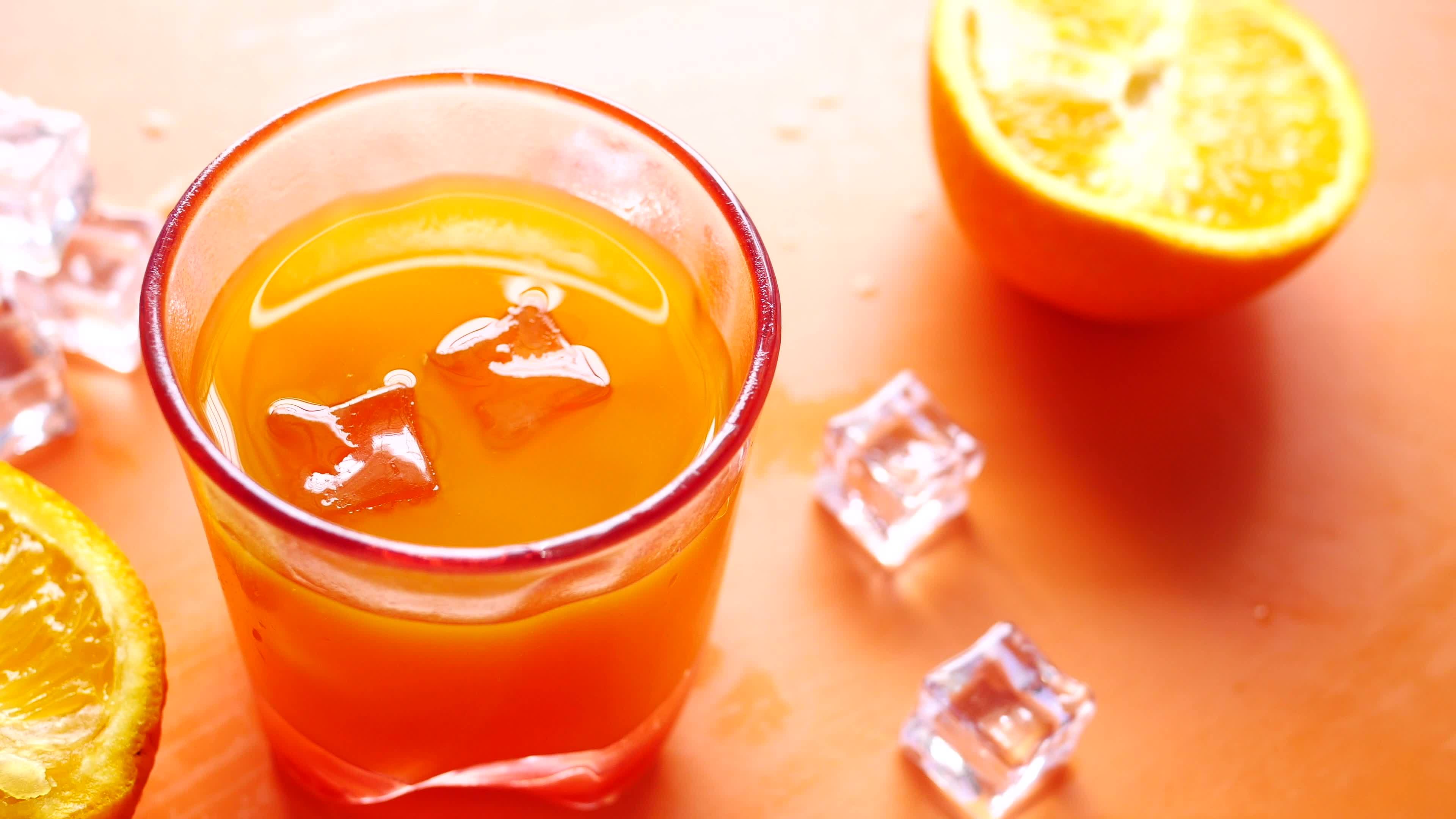 Sliced orange halves and juice with ice 13570890 Stock Video at Vecteezy