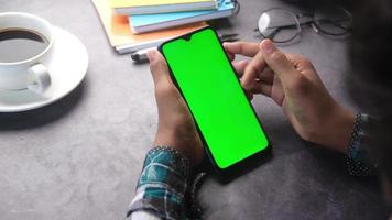 Student hand touching smartphone screen video