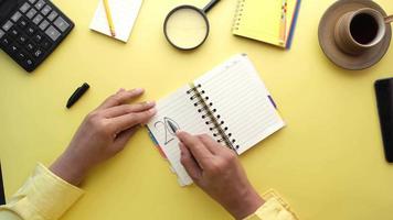 Man writing on planner, yellow background video