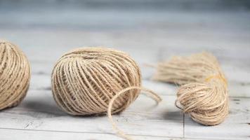 Balls of twine string on wood table top surface video