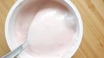 A spoon in strawberry yogurt video