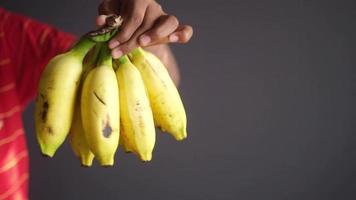 Man holding a ripe banana chunk video