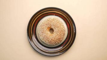 A plate with a sesame bagel top view video