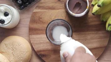 Pouring milk from a liter bottle to a glass video