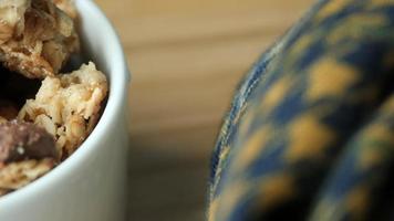 Close up texture of granola chunks in white ceramic dish video