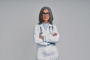 Mature beautiful female doctor looking at camera and smiling photo