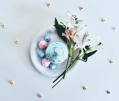 Delicious. High angle shot of cupcake and flowers against white background photo