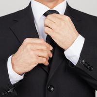 Making business look good. Cropped image of senior man in formalwear adjusting his while standing against grey background photo