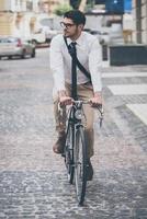 No traffic jams today  Confident young man in glasses looking away while riding his bicycle photo