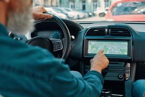 Close up rear view of active senior man using global positioning system photo