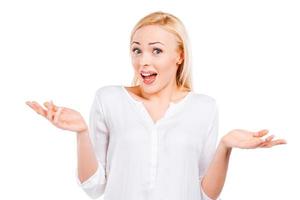 Something wrong is happening  Surprised mature woman stretching out hands and making a face while standing against white background photo