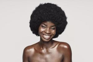 Portrait of beautiful young African woman looking at camera and smiling photo